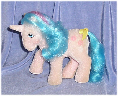 Electric
          blue unicorn with neon yellow mane and tail, red streak, bow